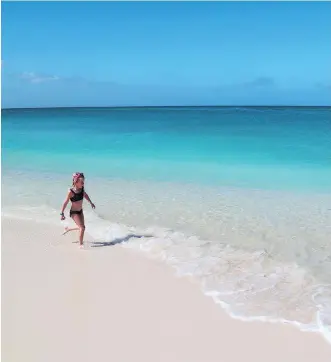  ??  ?? The writer’s daughter enjoyed the picture-perfect Seven Mile Beach on Grand Cayman.