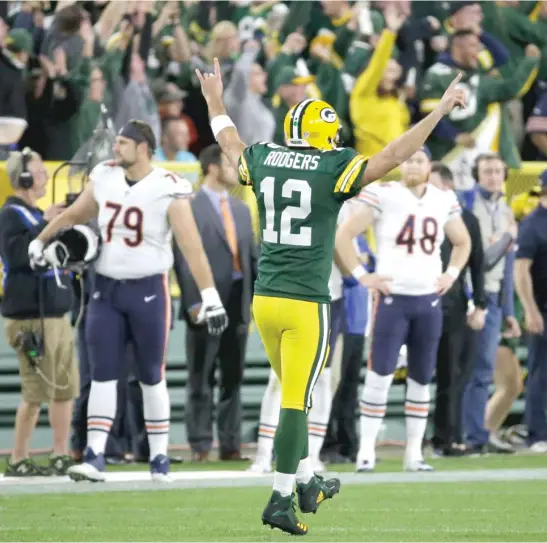  ?? MIKE ROEMER/AP ?? Packers quarterbac­k Aaron Rodgers (20-for-30, 286 yards) celebrates after throwing a 75-yard touchdown pass to Randall Cobb with 2:13 left to play.
