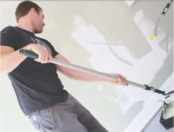  ?? ALEX SCHULDTZ/THE HOLMES GROUP ?? You don't have to be a profession­al, like Michael Holmes Jr., to paint your home. When painting, the room should be as empty as possible, so remove as much furniture as you can.