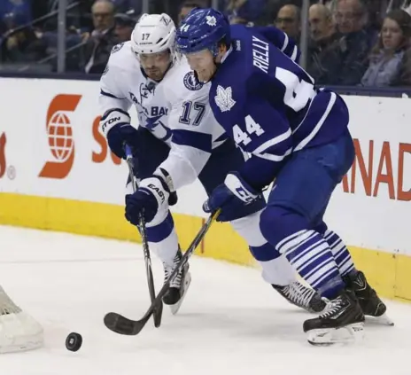  ?? RICK MADONIK/TORONTO STAR ?? Leafs defenceman Morgan Rielly strips the puck off Lightning centre Alex Killorn during second-period play Tuesday night at the ACC.