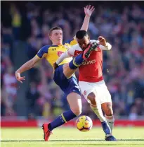  ?? GETTY ?? Arsenal’s Alexandre Lacazette is challenged by Southampto­n’s Matt Targett at the Emirates yesterday
