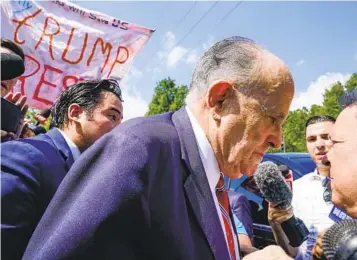  ?? BRYNN ANDERSON AP ?? Rudy Giuliani speaks outside the Fulton County jail Wednesday in Atlanta as he faces an indictment alleging he acted as former President Donald Trump’s chief co-conspirato­r in a plot to subvert the 2020 election.