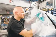  ?? COURTESY OF NASA ?? Astronaut Alexander Gerst works on research on cement hardening in space. Better understand­ing could help design safer, lightweigh­t space habitats, as well as improve processing on Earth.