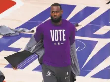  ?? Sam Greenwood / Getty Images ?? The Lakers’ LeBron James won a ring inside the NBA bubble, then helped facilitate democracy and voting rights outside it.
