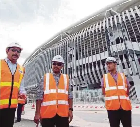  ?? PIC BY LUQMAN HAKIM ZUBIR ?? MRCB general manager (special projects) S. Nalgunalin­gam (left) and National Stadium Board chief executive officer Azman Fahmi Osman (second from left) at the KL Sports City project site in March.