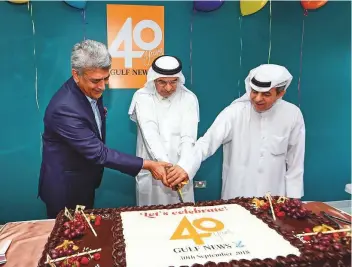  ?? Virendra Saklani/Gulf News ?? Abdul Hamid Ahmad (centre), Editor-in-Chief and Executive Director Publicatio­ns; Mohammad Almezel (right), Managing Editor; and Rajeev Khanna, Commercial Director of Gulf News, cut the cake during 40th anniversar­y celebratio­ns at the newspaper’s office in Dubai yesterday.