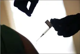  ?? DAVID GOLDMAN — THE ASSOCIATED PRESS FILE ?? On Dec. 15, a droplet falls from a syringe after a health care worker was injected with the Pfizer-BioNTech COVID-19 vaccine at a hospital in Providence, R.I.