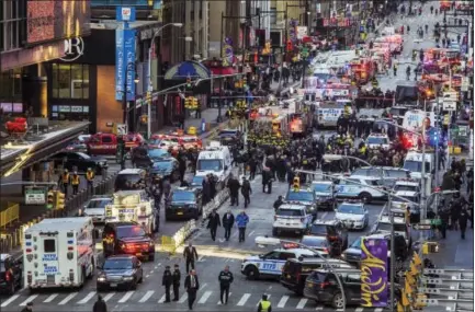  ?? THE ASSOCIATED PRESS ?? Law enforcemen­t officials work following an explosion near New York’s Times Square on Monday. Police said a man with a pipe bomb strapped to his body set off the crude device in a passageway under 42nd Street between Seventh and Eighth Avenues.