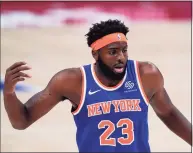  ?? Carlos Osorio / Associated Press ?? New York Knicks center Mitchell Robinson plays during the first half of a preseason NBA game on Friday in Detroit. Robinson and Nerlens Noel are in contention for the starting center job, with only one problem — they play the same style of basketball.