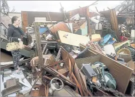  ?? PEDRO PORTAL — THE ASSOCIATED PRESS ?? Haley Nelson inspects damage to her family properties in Panama City, Fla., after Hurricane Michael made landfall in Florida’s Panhandle on Wednesday. The hurricane splintered homes and submerged neighborho­ods before continuing its march inland.