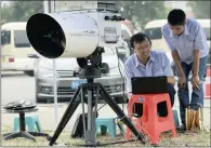  ?? PICTURE: REUTERS ?? CHECKING POLLUTION: Tianjin environmen­tal monitoring centre engineers use a device to check the level of hydrogen cyanide in the air at a station observing environmen­tal pollution near the site of the blasts.