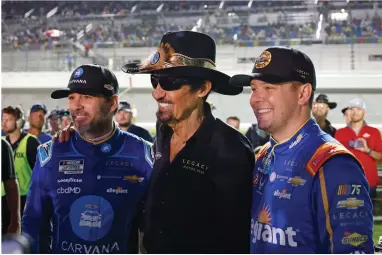  ?? AP PHOTO BY TERRY RENNA ?? Former NASCAR driver Richard Petty, center, poses for a photo with Jimmie Johnson, left, and Erik Jones, right, before the first of two qualifying auto races for the NASCAR Daytona 500 at Daytona Internatio­nal Speedway, Thursday, Feb. 16, 2023, in Daytona Beach, Fla.