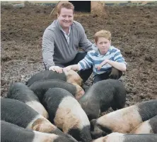  ??  ?? Mark and his son Charlie, then 11, who used to muck in breeding pigs for his dad’s company. They’re pictured here in 2011. Mark was passionate about using local produce in his venues.