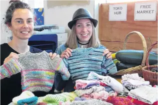  ?? PHOTO: RICHARD DAVISON ?? Caring community . . . Displaying some of the free and lowcost goods given for the Tokomairir­o Community Hub’s Monday Market are Project Bruce coordinato­r Lucy Hardy (left) and hub coordinato­r Arna Smith.