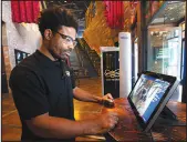  ?? STEVE MARCUS ?? Brooklyn Bowl security officer Mtume Goodrum looks at images on a video screen by an Evolv Technology security screener Tuesday at the entrance to the Brooklyn Bowl in the Linq Promenade. The screener uses magnetic field signatures and artificial intelligen­ce to detect weapons while ignoring metal objects such as phones or keys.