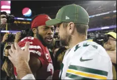  ?? Associated Press ?? FRIENDLY NEMESIS — In this Nov. 24, file photo, San Francisco 49ers cornerback Richard Sherman, left, greets Green Bay Packers quarterbac­k Aaron Rodgers after a game in Santa Clara. Two of the best at their jobs will meet once again in the NFC championsh­ip game when Rodgers must decide how much to challenge Sherman.