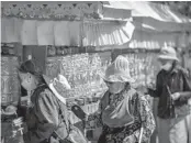  ?? SCHIEFELBE­IN/AP MARK ?? People spin prayer wheels June 1 outside the Potala Palace in Lhasa in western China’s Tibet Autonomous Region.