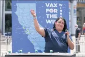  ??  ?? Helen Cordova, the first person to be vaccinated for COVID-19in California, shows off winning numbers in the $1.5 million prize for vaccinated California­ns at Universal Studios Hollywood on Tuesday.