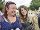  ??  ?? Nina Griffiths and Kirstie Matthews make friends with “Charlie” the Barn Owl