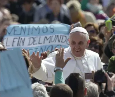  ??  ?? Pope Francis gets very personal with the crowd as he arrives for his weekly general audience in St. Peter’s Square.