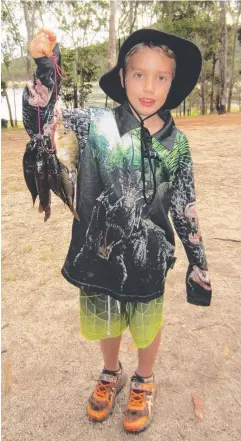  ??  ?? FINE HAUL: Jayden McKenzie, 7, of Gordonvale, caught five tilapia on the first day of the competitio­n.
