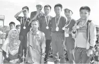  ??  ?? KASIMAN dan Suzanah Penolong Kokurikulu­m SMK Beluran bersama barisan pemenang acara 4x100M L12.