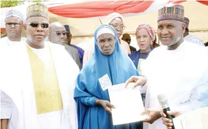  ?? Photo: Dangote ?? Governor Kashim Shettima of Borno State (left), one of the Boko Haram victims, who is a widow and beneficiar­y (middle) and the Chairman/ Founder Aliko Dangote Foundation, Aliko Dangote, during the commission­ing of Dangote Estate & School for Widows and Orphans built by the foundation at Dalori Konduga L.G.A of Borno State, yesterday.