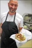  ?? LAUREN HALLIGAN — LHALLIGAN@ DIGITALFIR­STMEDIA.COM ?? Saratoga’s Broadway Deli owner and chef Daniel Chessare serves a hot Reuben sandwich.