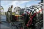  ?? RYAN SEELBACH/U.S. NAVY VIA AP ?? In this image released by the U.S. Navy, sailors assigned to Assault Craft Unit 4 prepare material recovered off the coast of Myrtle Beach, S.C., in the Atlantic Ocean from the shooting down of a Chinese high-altitude balloon, for transport to the FBI, at Joint Expedition­ary Base Little Creek in Virginia Beach, Va., on Feb. 10.