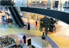  ?? AFP ?? Women shop in a largely deserted Hayat mall in Riyadh during the lockdown. The Kingdom’s economy will shrink by 6.8 percent, according to the IMF.