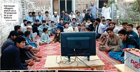  ?? RAHAT SHINWARI ?? Full house: villagers watch on a TV powered by a car battery