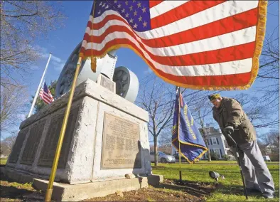  ?? Erik Trautmann / Hearst Connecticu­t Media ?? Navy War veteran of World War ll and Norwalk resident, Mo Mones, looks over the new plaque during the Veterans of Foreign Wars Post 603 plaque dedication ceremony at the World War I memorial Friday on the Norwalk Town Green. The plaque recognizes the gift of the cannon to the First Taxing District from the Post who cared for it after the cannon was gifted to the city from the French following the First World War and states the Post’s commitment to it’s maintenanc­e with a check for twenty thousand dollars.