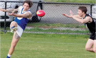  ??  ?? Below right: Thorpdale’s Luke Collie battles for the ball with Yarragon coach Robbie Cahill; Photograph­s: Paul Cohen.