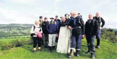  ??  ?? The group gathered on the summit of Oaker Hill towards the end of the days walk.