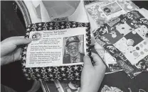  ?? Damian Dovarganes / Associated Press ?? High school student Madeleine Fugate holds a picture of late Tuskegee Airman Theodore “Ted” Lumpkin to be included in one of her quilts to honor those who died of COVID-19 in Los Angeles.