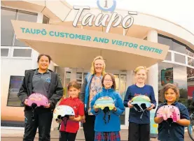  ?? ?? The ‘design your own helmet’ competitio­n winners (front left to right) Honey Rata–Hurst, Mila Whelan, Suji Bramall, George Fisher and Zendaya Jenner were presented with their creations by Taupō District Council’s Sarah Wraight (behind).