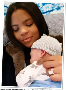  ??  ?? FOCUS OF CURIOSITY: Candace Owens cradling her baby son