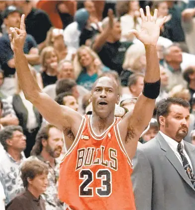  ?? MARK J. TERRILL/ASSOCIATED PRESS FILE ?? Chicago Bulls guard Michael Jordan holds up six fingers for the six NBA Championsh­ips the Bulls have won after their 1998 title.