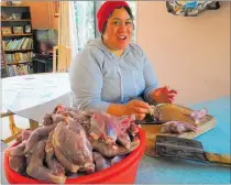  ?? PICTURE / SUPPLIED ?? Conservati­on Festival organiser Stella Schmid preparing the protein for her mutton and possum sausages, or possages.