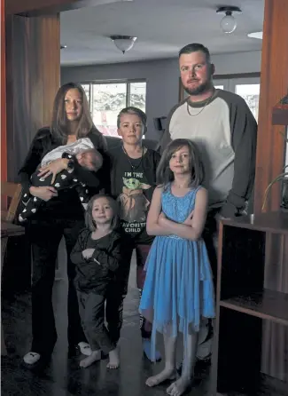  ?? AAron Ontiveroz, The Denver Post ?? Seth and Julie McLean with their children Merida (baby), Layne, 10, Keira, 7, and Artaivia, 3, on Wednesday in Wheat Ridge. The McClean family had a difficult time using all the credits they were owed by Frontier Airlines after a flight cancellati­on, and Seth eventually filed a complaint with the Colorado attorney general’s office.