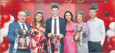  ?? (Pic: Catherine Sheehan) ?? Proudly displaying the silverware attained by All-Ireland champions, Ballygibli­n are the O’Doherty family.