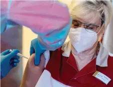  ?? — AFP file photo ?? Geriatric nurse Ina Voss is given a dose of the Pfizer-Biontech Covid-19 corona virus vaccine by a member of the German Red Cross in a retirement home in Zolling, southern Germany.