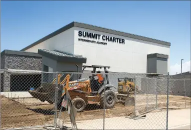  ?? RECORDER PHOTOS BY CHIEKO HARA ?? Constructi­on crews continue to work on Burton School District’s new Summit Charter Intermedia­te Academy Friday, July 13. The school is scheduled to open for the upcoming academic year, and will be home to students grade six through eight.