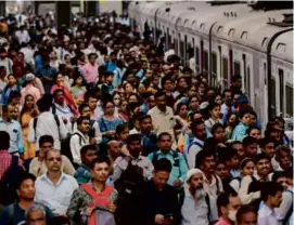  ?? PUNIT PARANJPE/AFP VIA GETTY IMAGES ?? People crowded the platform Wednesday while waiting for their train at a railway station in Mumbai.