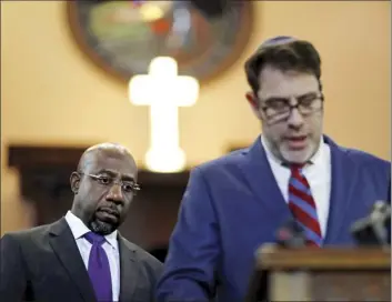  ?? AP photo ?? Rev. Raphael Warnock (left) listens as Rabbi Peter Berg responds to President Donald Trump’s comments about Haiti and Africa at Ebenezer Baptist Church where Rev. Martin Luther King Jr. preached in Atlanta. Warnock and other faith leaders condemned...