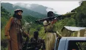  ?? ISHTIAQ MAHSUD — THE ASSOCIATED PRESS FILE ?? Pakistani Taliban patrol in their stronghold of Shawal in the Pakistani tribal region of South Waziristan.