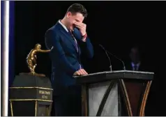  ?? TODD VAN EMST / AP ?? LSU quarterbac­k Joe Burrow reacts after being awarded the Heisman Trophy on Saturday in New York.