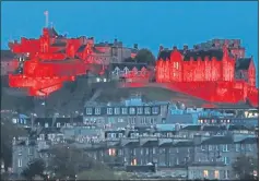  ??  ?? Edinburgh Castle is just one of the buildings lit red last night