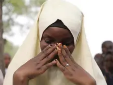  ?? Ap phOTOS ?? WASN’T TAKEN: One of the students who was not kidnapped from a Government Girls Junior Secondary School holds her hands over her face following an attack by gunmen in Jangebe, Nigeria, Friday.