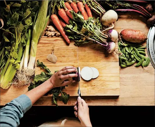  ?? PEOPLEIMAG­ES/GETTY ?? Besides potentiall­y improving your health, cooking your own food supports the local economy, particular­ly if you’re shopping at farmers markets and local establishm­ents.